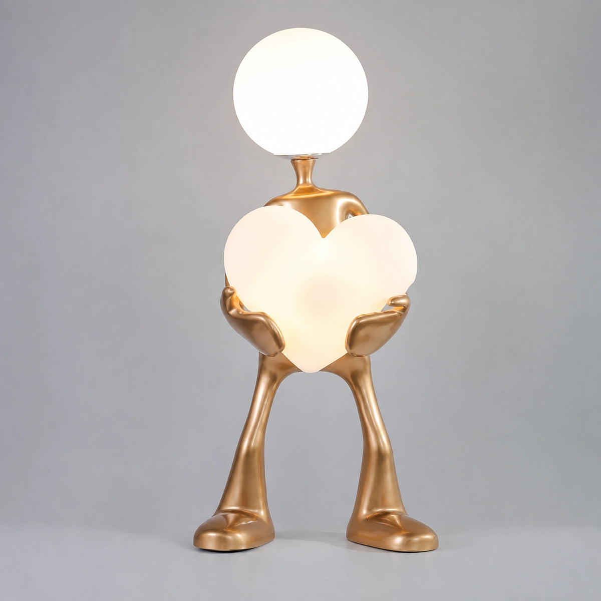 Gold Figure Holding Heart-Shaped Globe Floor Lamp