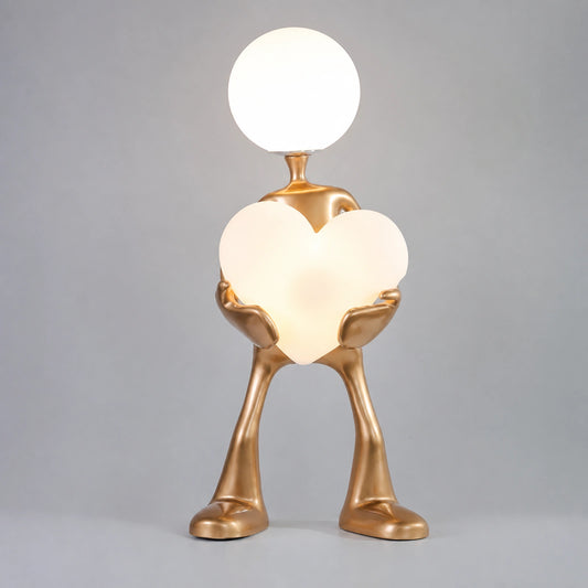 Gold Figure Holding Heart-Shaped Globe Floor Lamp
